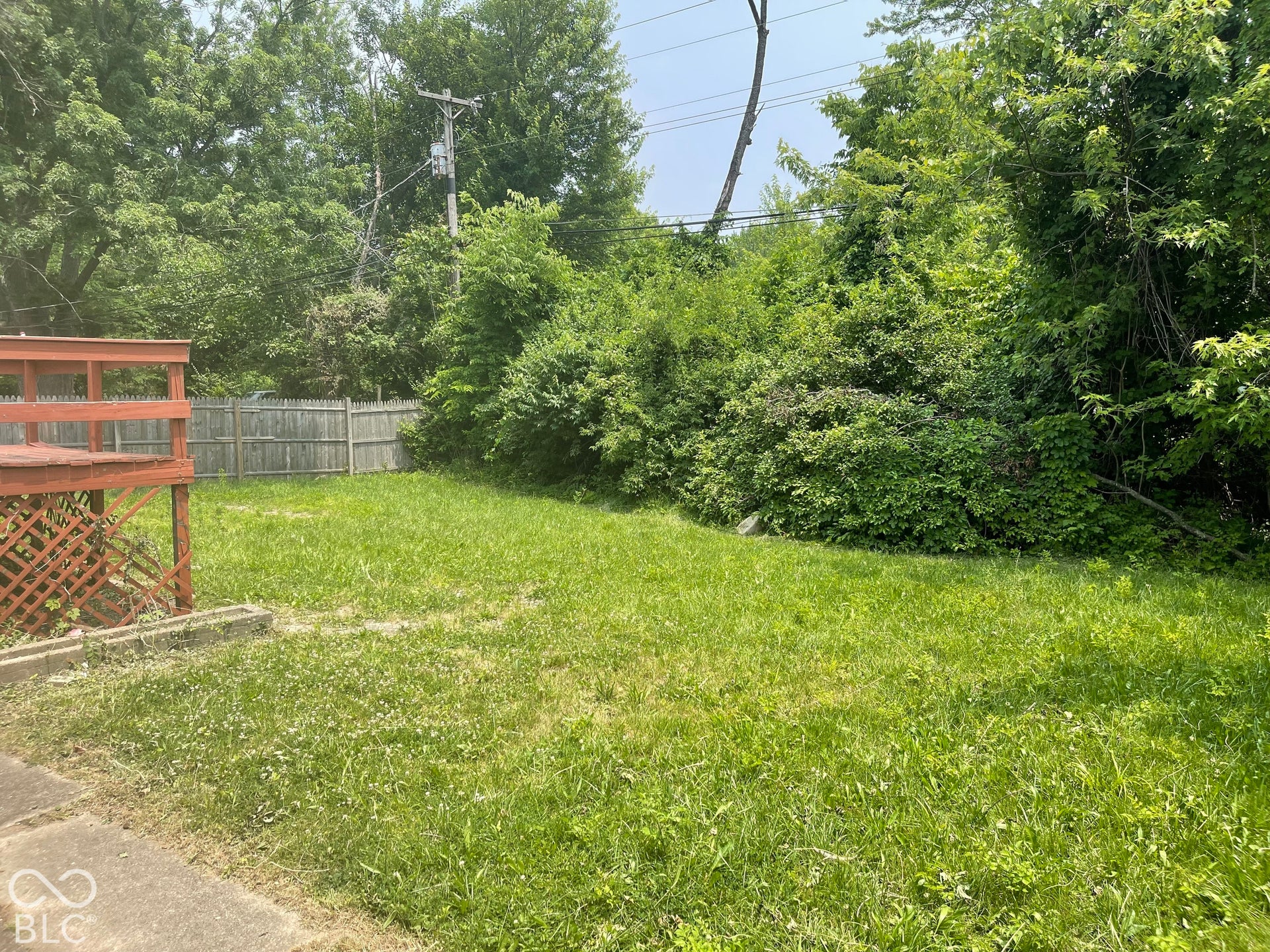 3913 Eisenhower Drive, Indianapolis, IN 46254 Expansive rear yard featuring green space, mature trees, and a wooden privacy fence