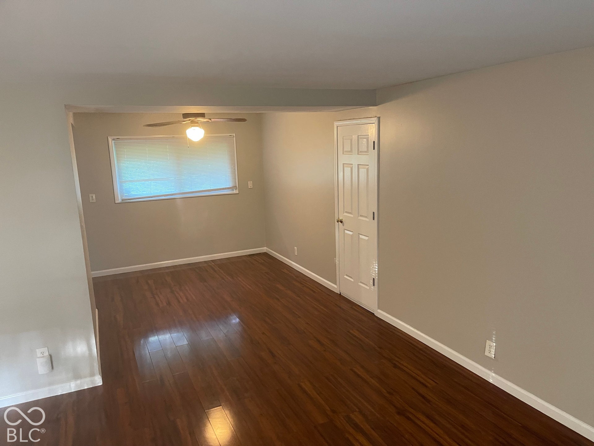 3913 Eisenhower Drive, Indianapolis, IN 46254 Wood-finish flooring, neutral wall tones, ceiling fan with integrated lighting, and a paneled interior door