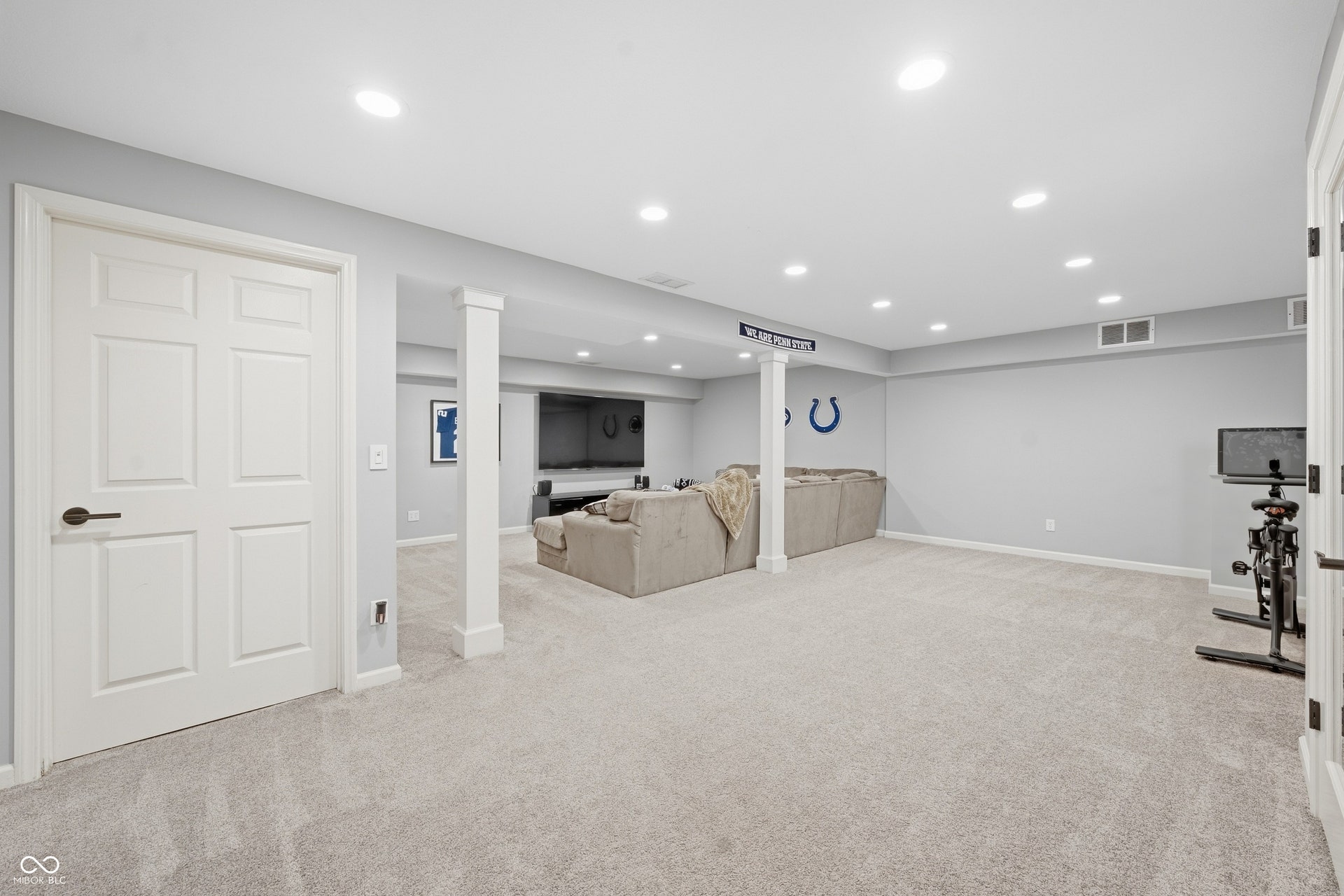 Recessed ceiling lighting, light gray wall paint, white trim, paneled interior doors, and carpet flooring