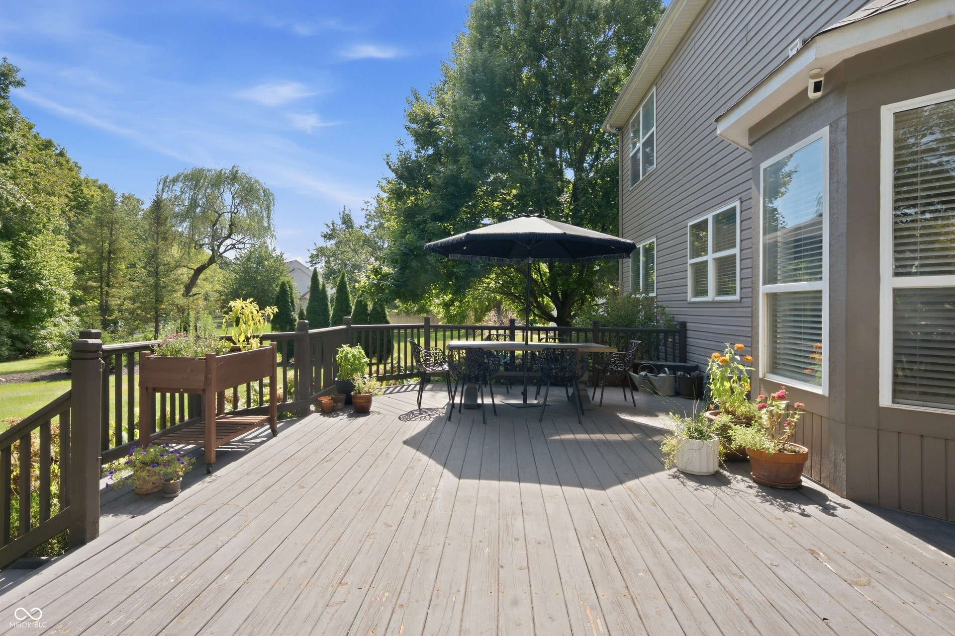 Wood-finish deck with dark-stained railings and siding