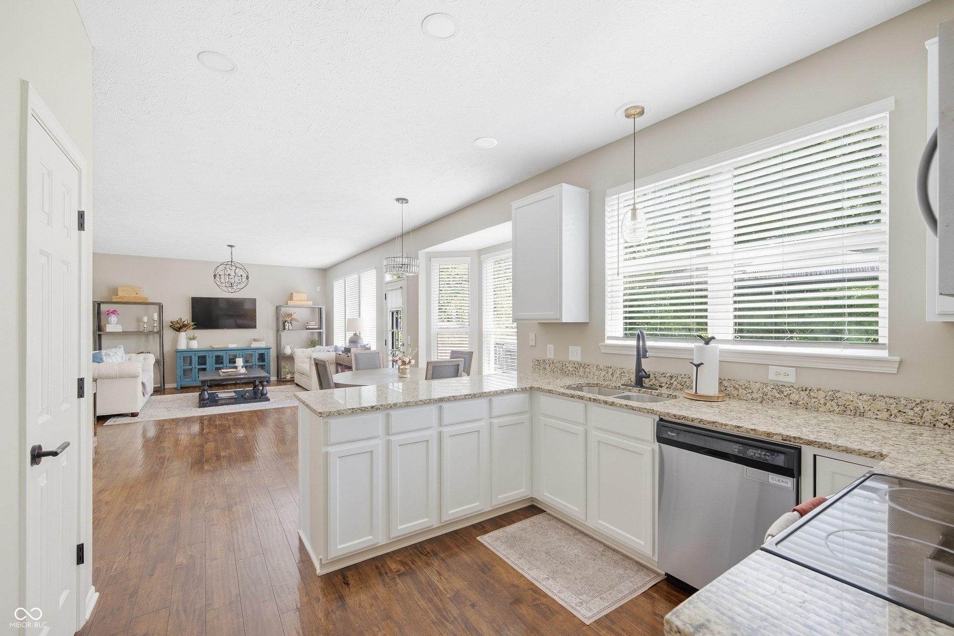 Kitchen with white cabinetry, light-toned countertops, and stainless steel appliances