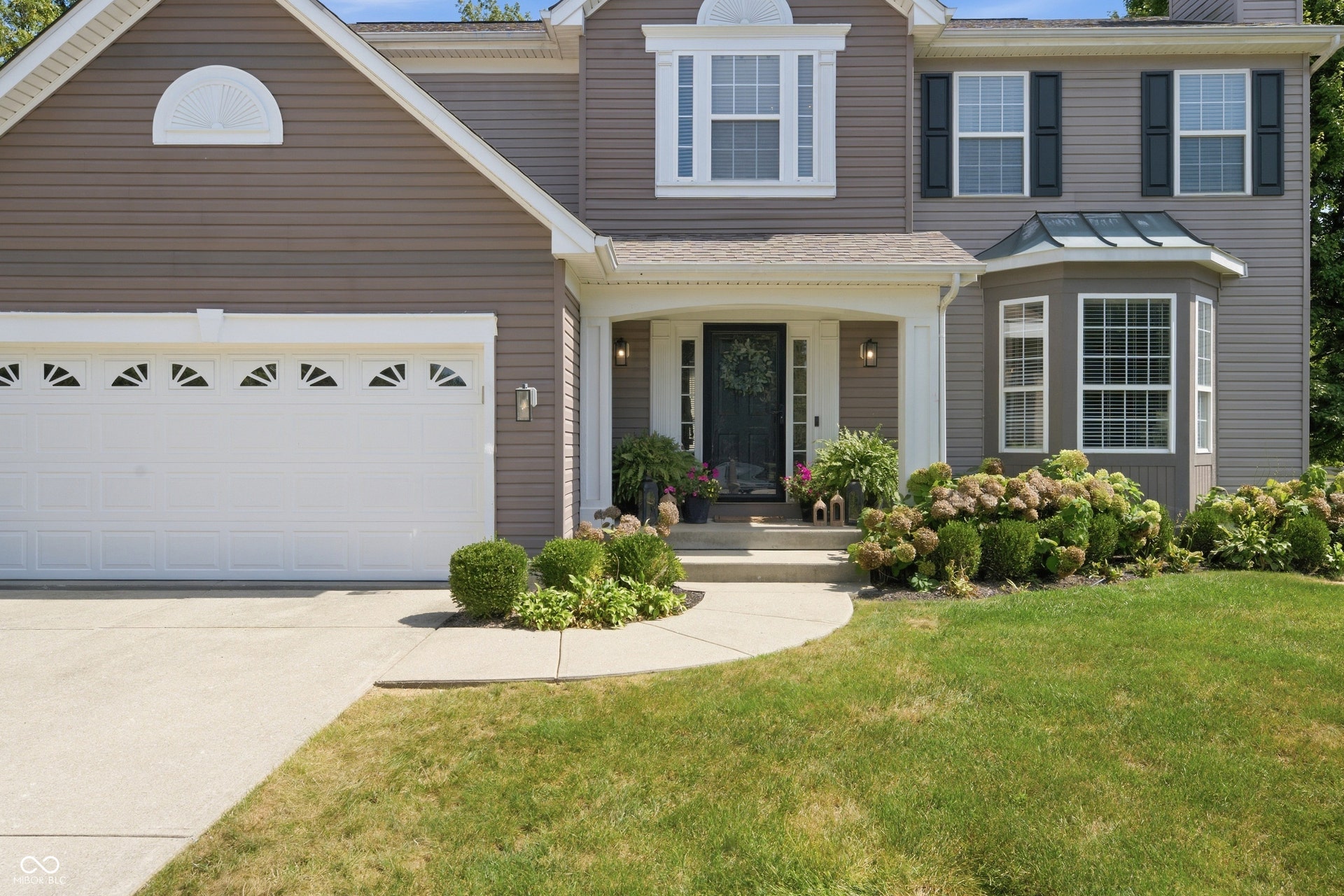 Brown siding exterior with white trim accents