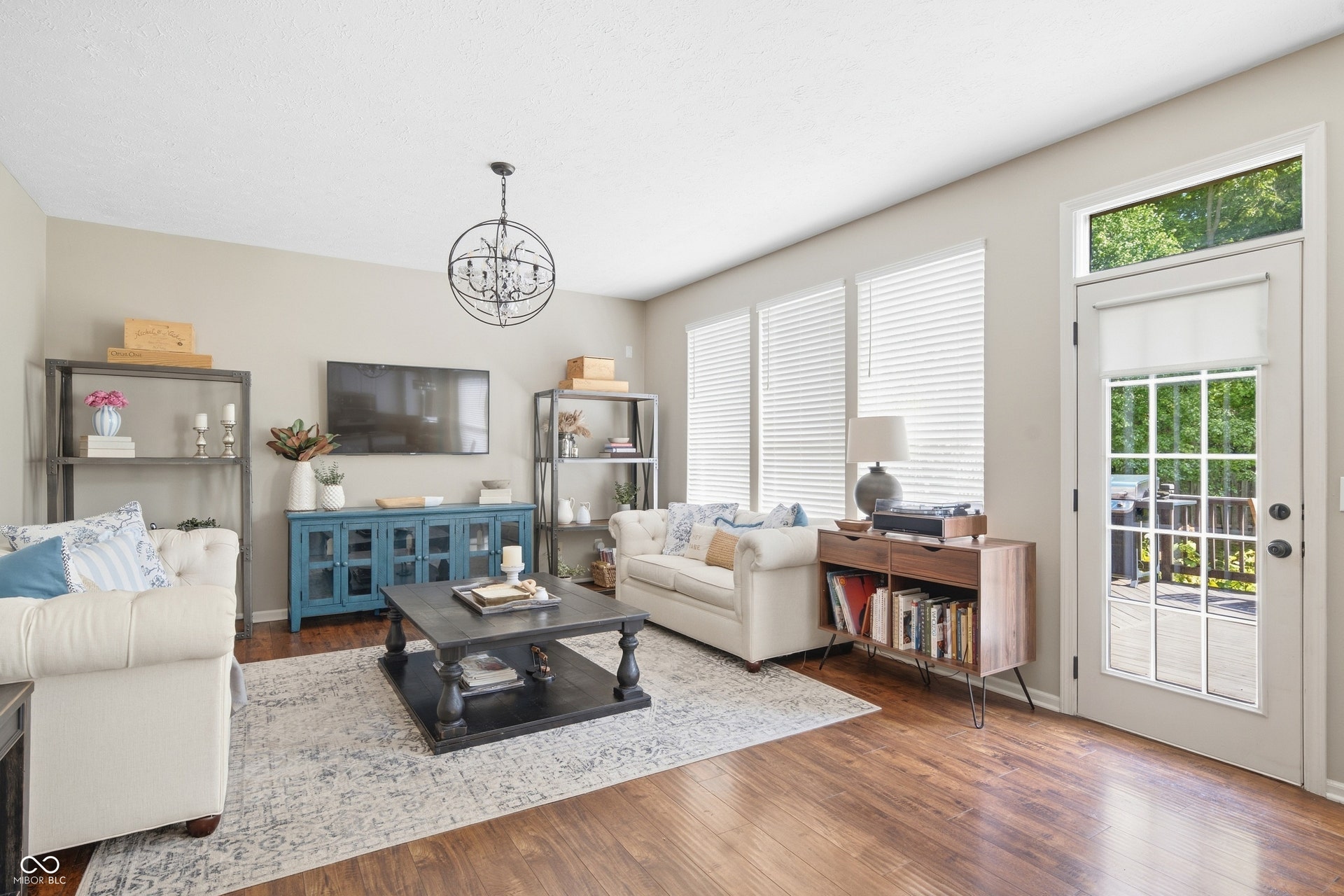 Hardwood-finish flooring throughout, bright interiors with multiple windows, and a glass-paneled door