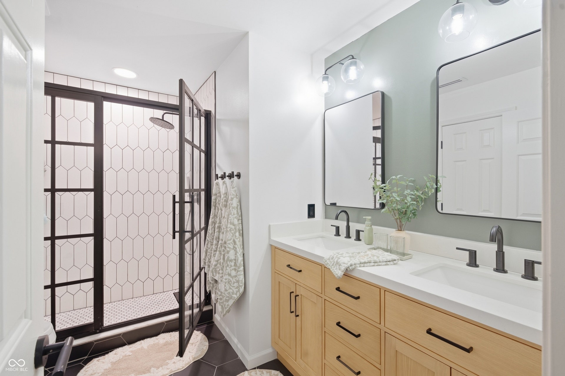 Double vanity with wood-finish cabinetry and white countertops