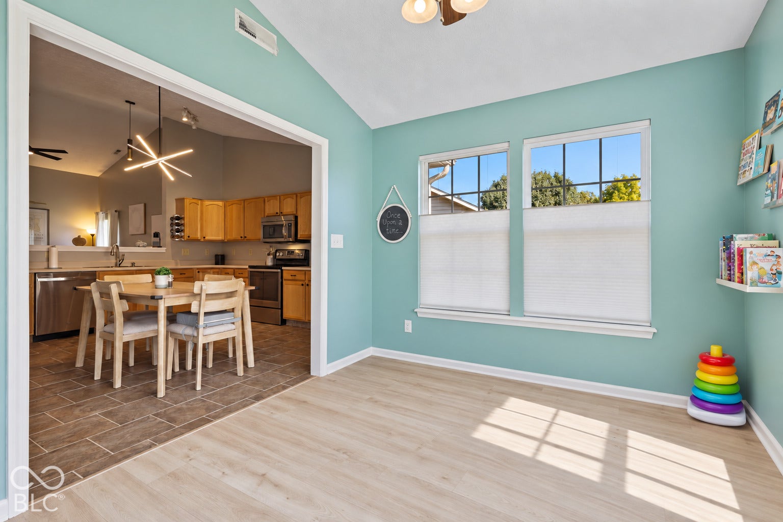 Vaulted ceiling, wood-finish flooring, dual windows with built-in shades, and arched entryway