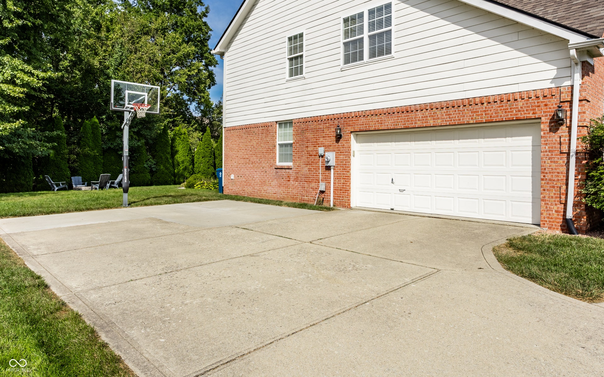 Brick and siding exterior with a large two-car garage