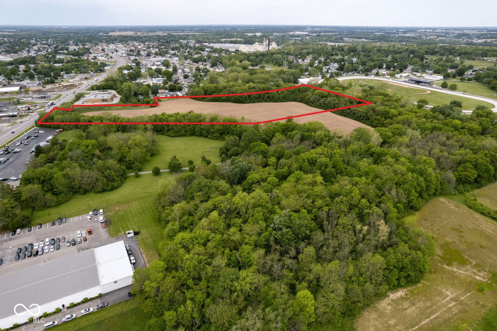 Expansive multi-acre property featuring mature tree coverage, open green space, and cleared acreage suitable for development or agricultural use