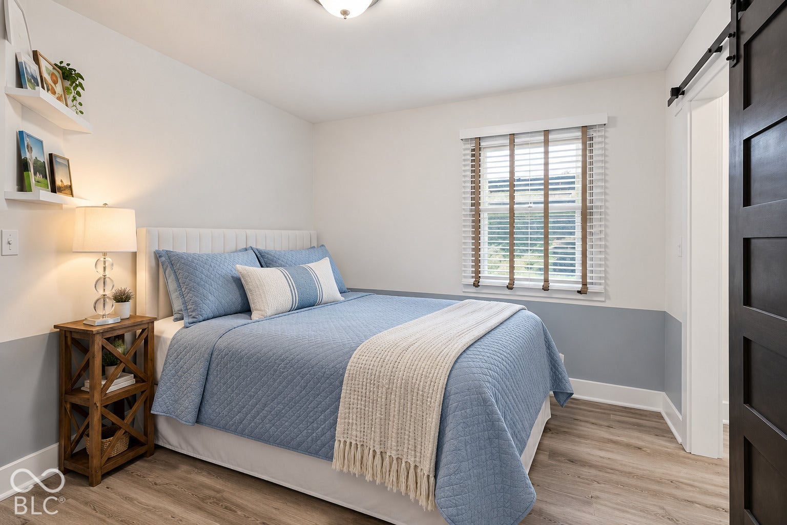Wood-finish flooring, white walls with a contrasting lower accent, and a window with blinds