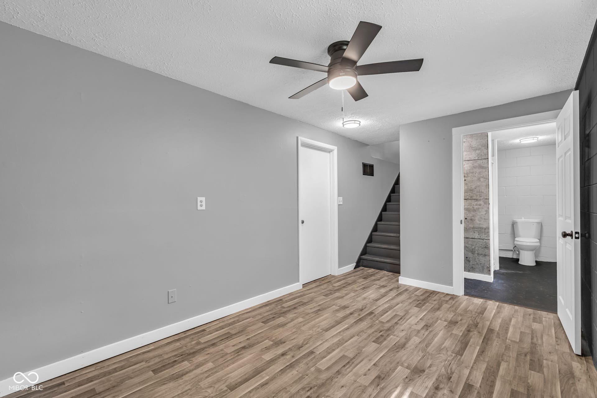Wood-finish flooring with light gray walls and white trim