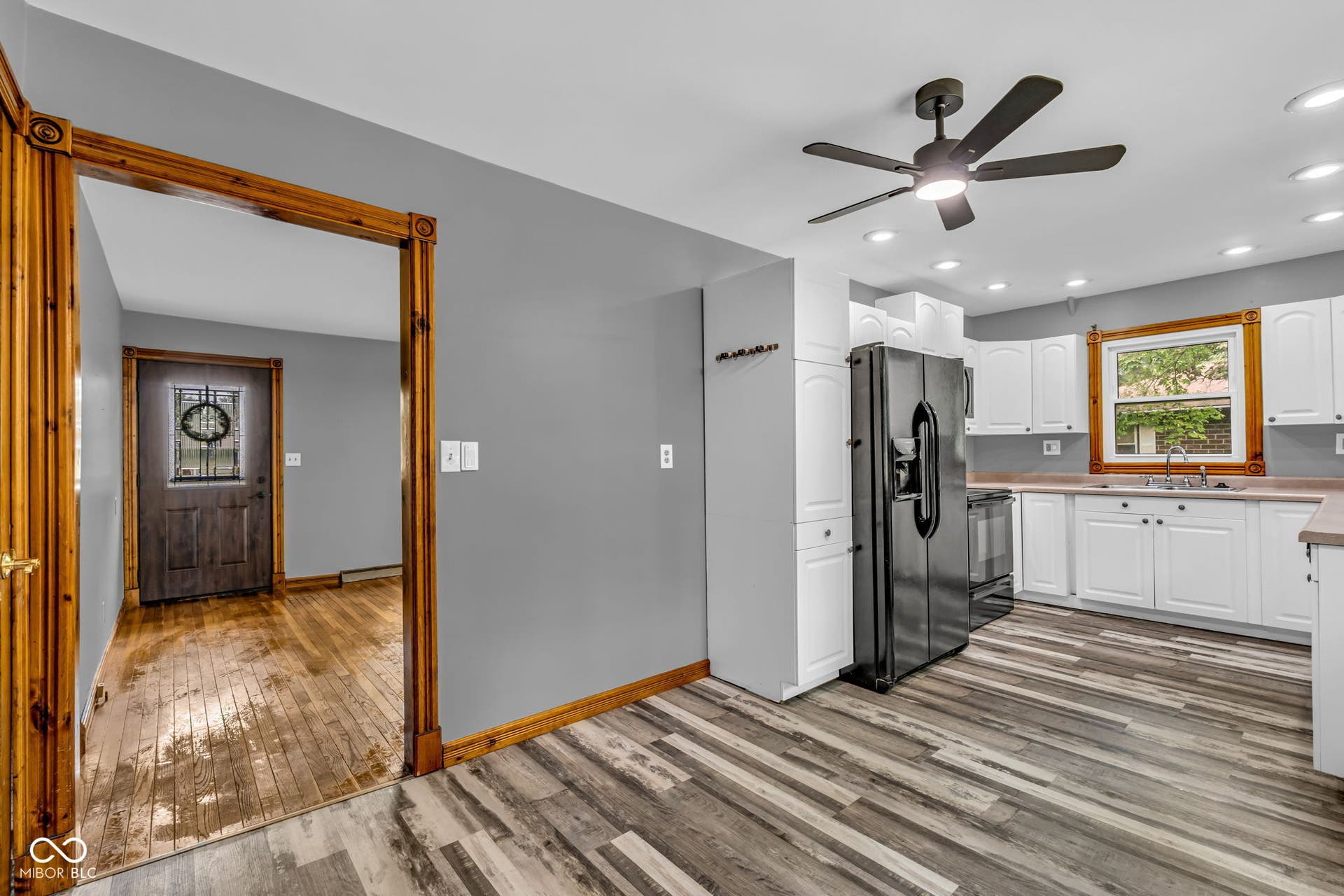 Kitchen featuring wood-finish flooring, white cabinetry, dark countertops, a multi-speed ceiling fan, and recessed lighting