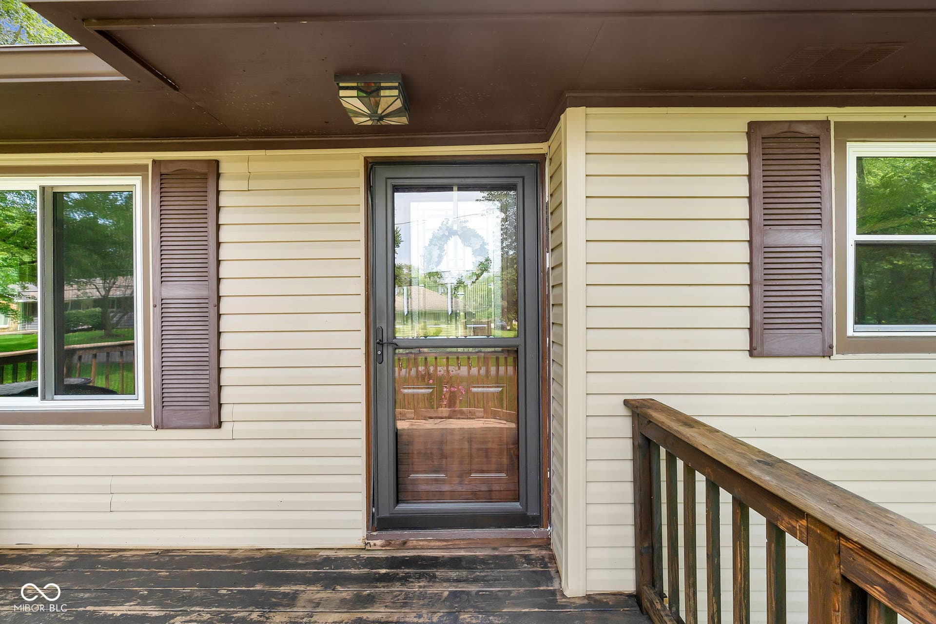 Exterior siding with contrasting louvered shutters