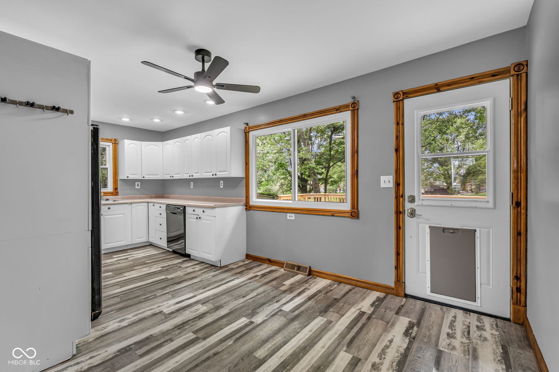Kitchen featuring white cabinetry, light countertops, wood-finish flooring, recessed lighting, and a ceiling fan