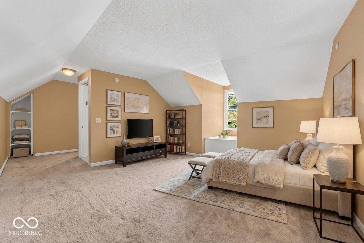 Sloped ceilings, built-in shelving, and a prominent window