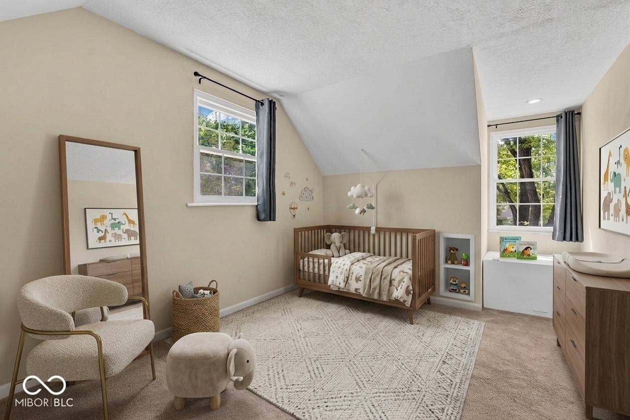 Sloped ceiling room featuring two windows, neutral wall tones, and carpeted flooring