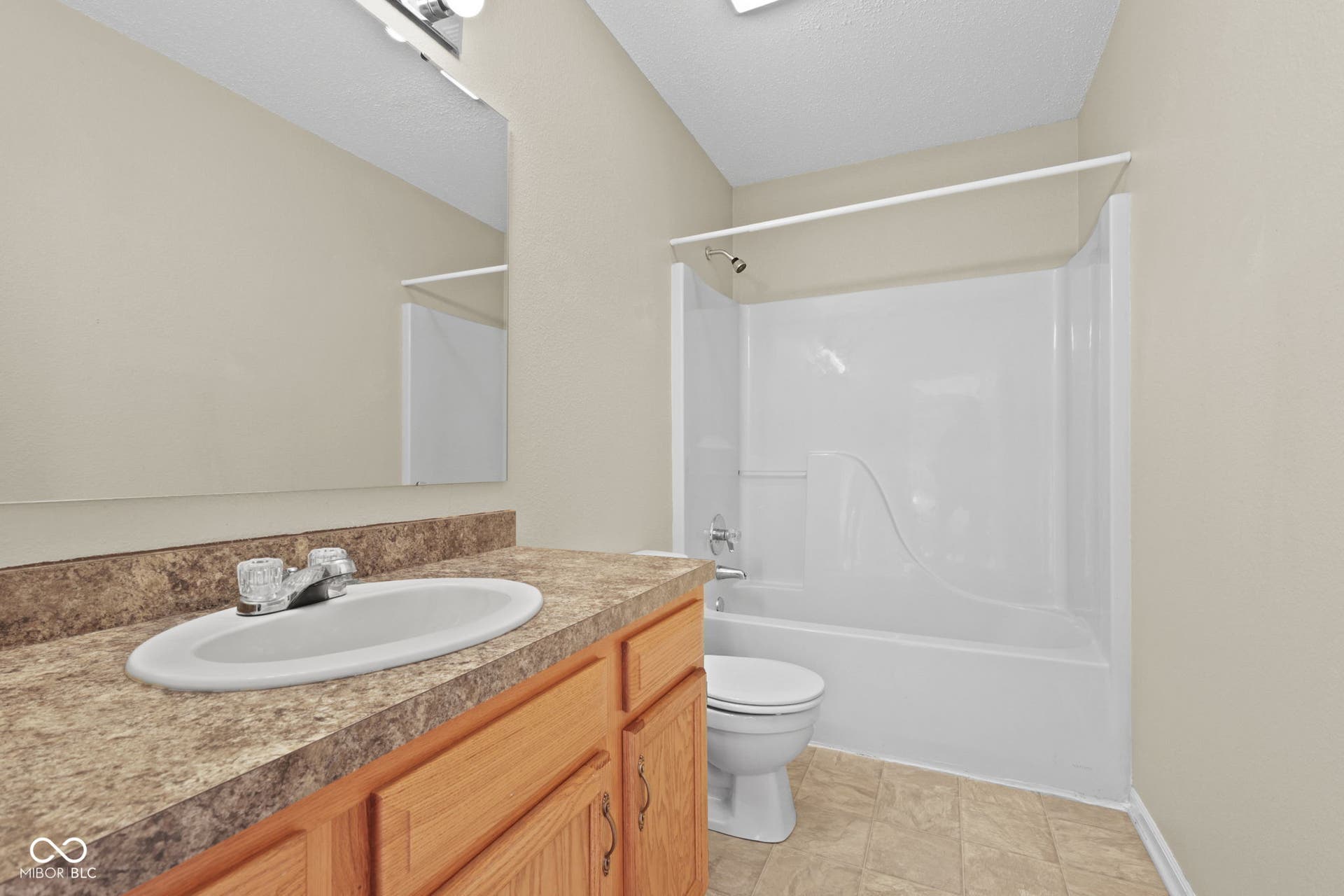 Full secondary bathroom featuring a convenient tub and shower combination.