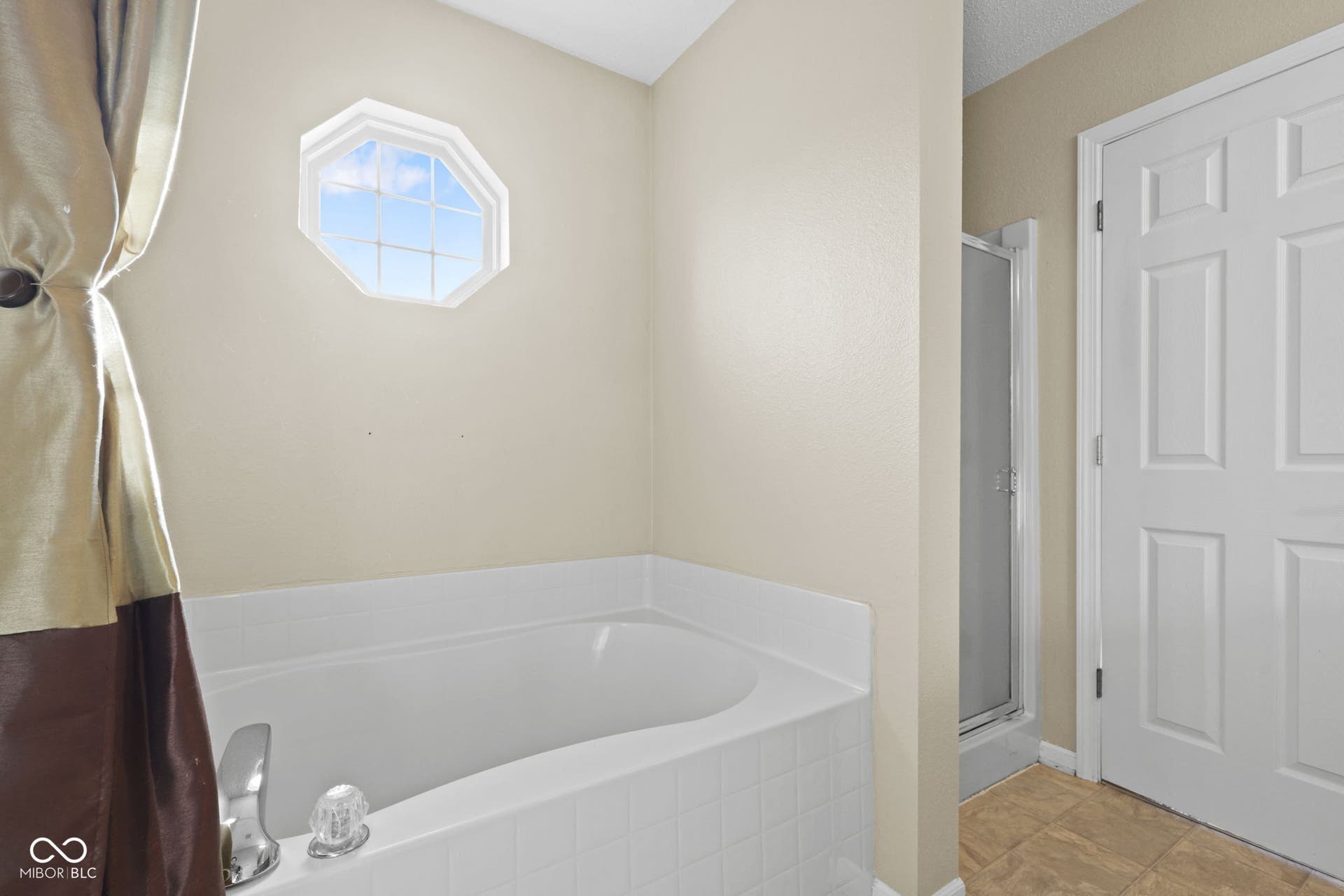 Primary bathroom featuring a full-size tub for added comfort and convenience.