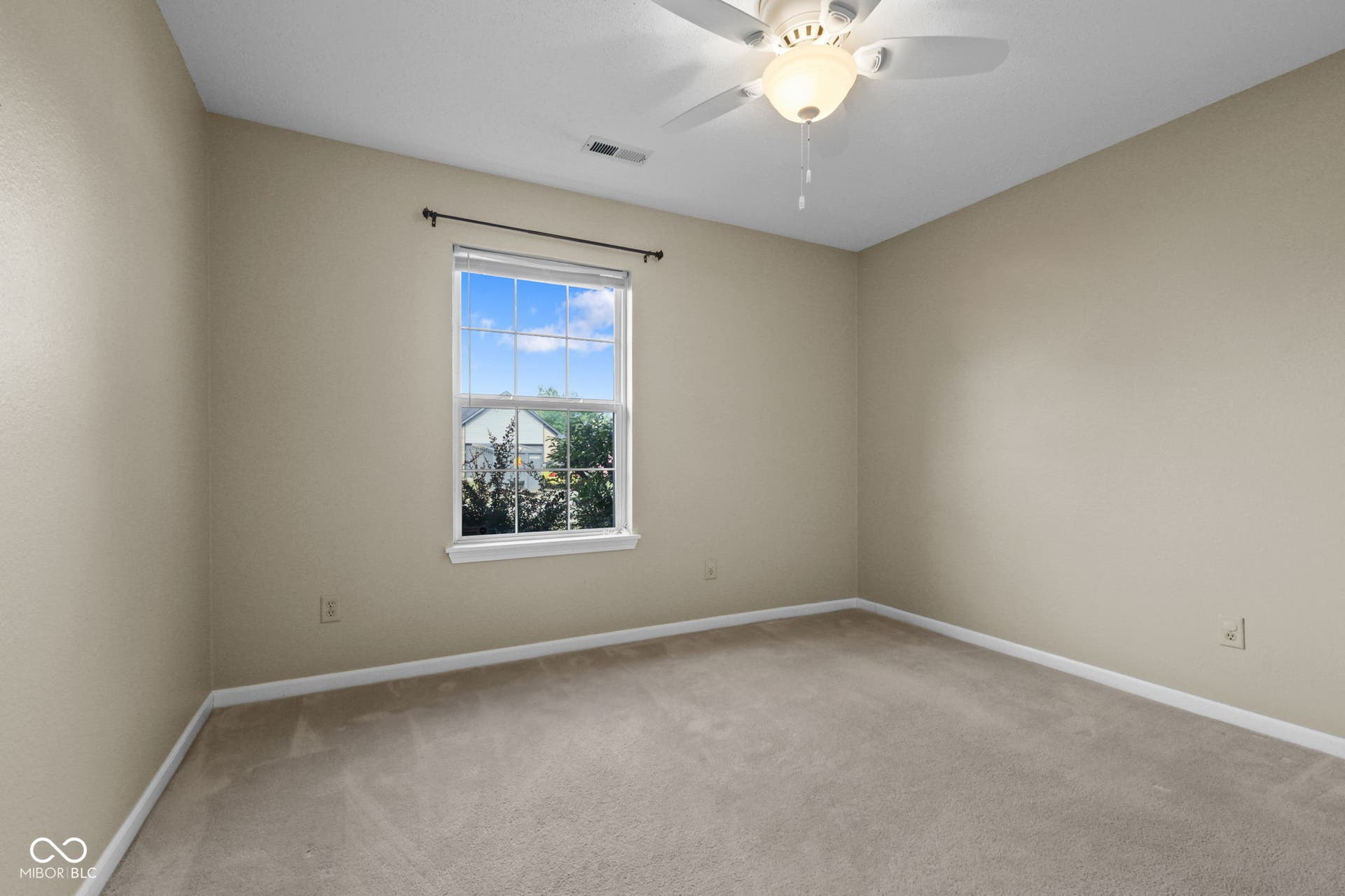 Comfortable secondary bedroom offering great natural light and flexible living space.