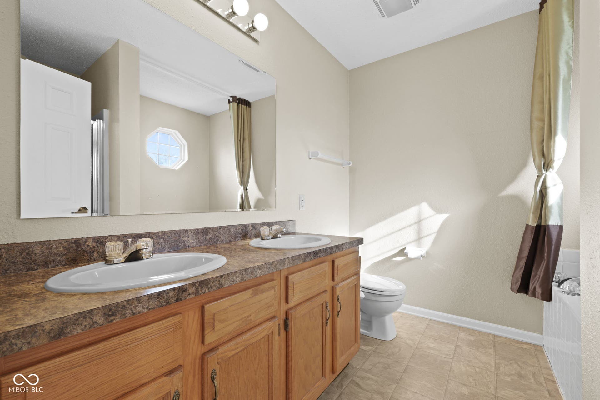 Primary bathroom featuring double vanities for added space and convenience.