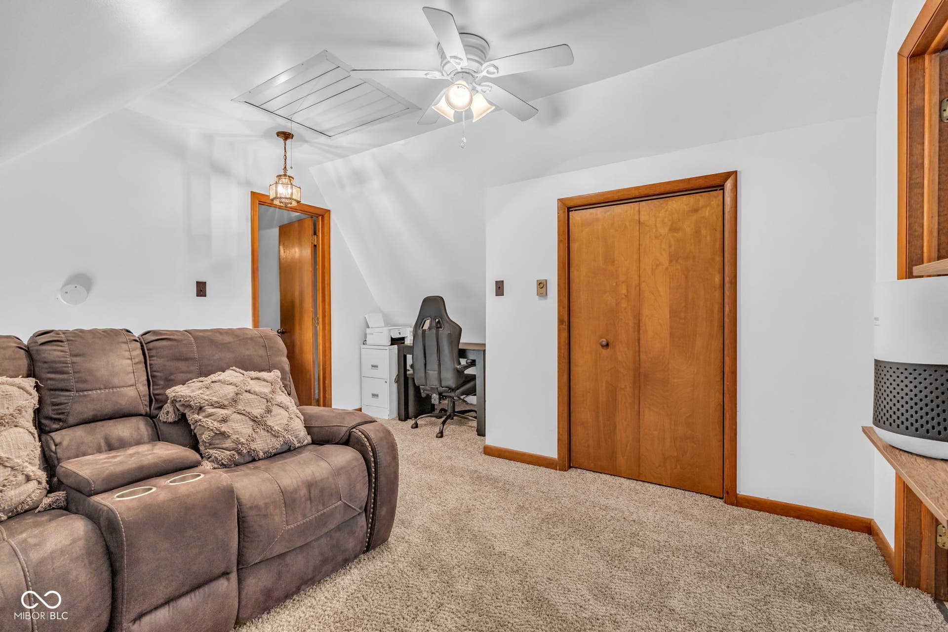 5432 W Whittier Drive, Knightstown, IN 46148 Angled ceiling room featuring carpet flooring, natural wood-finish doors, a ceiling fan, and a drop-down attic access panel