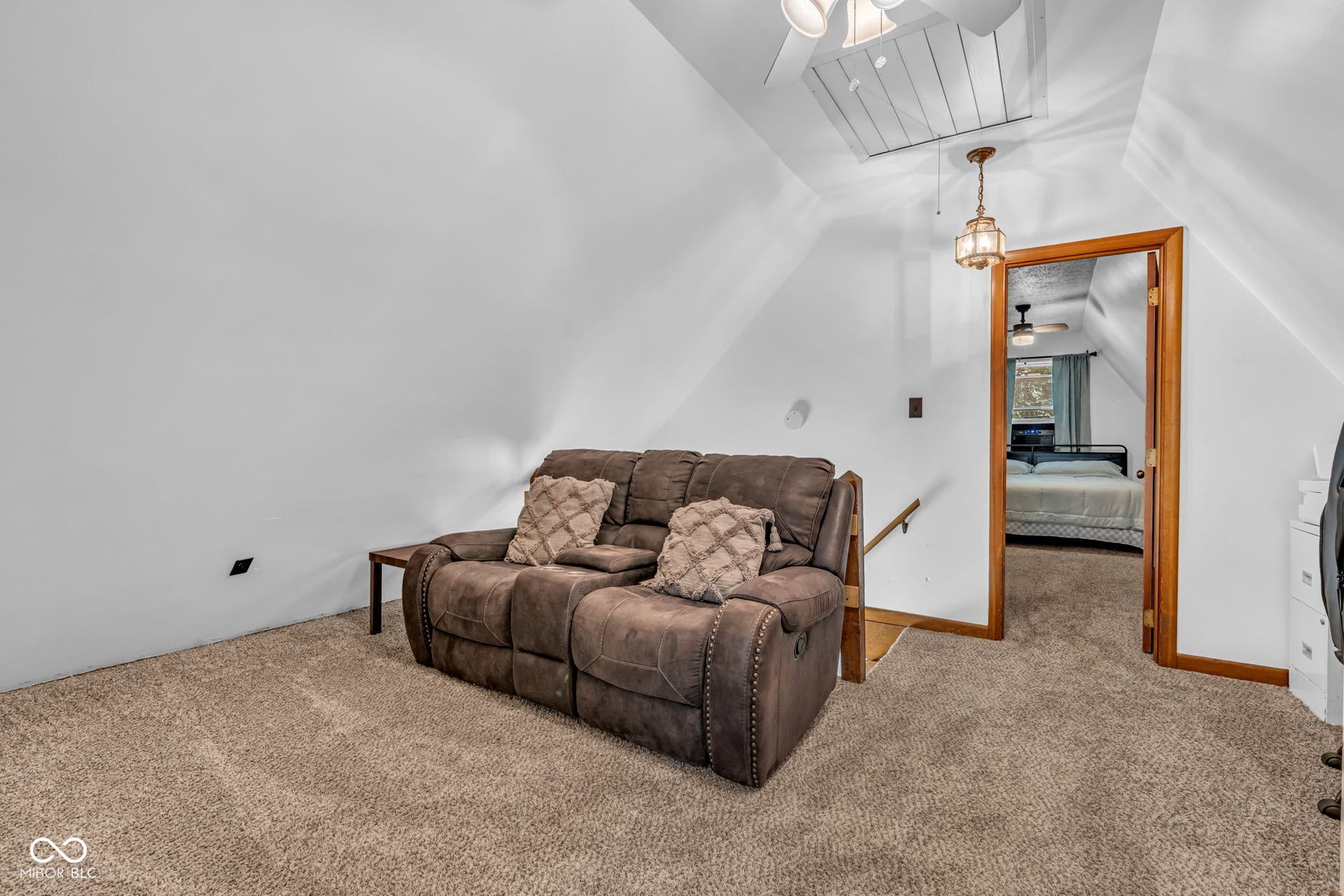 5432 W Whittier Drive, Knightstown, IN 46148 Carpeted flooring, sloped white walls, wood-trimmed doorway, and a ceiling fan with light fixture