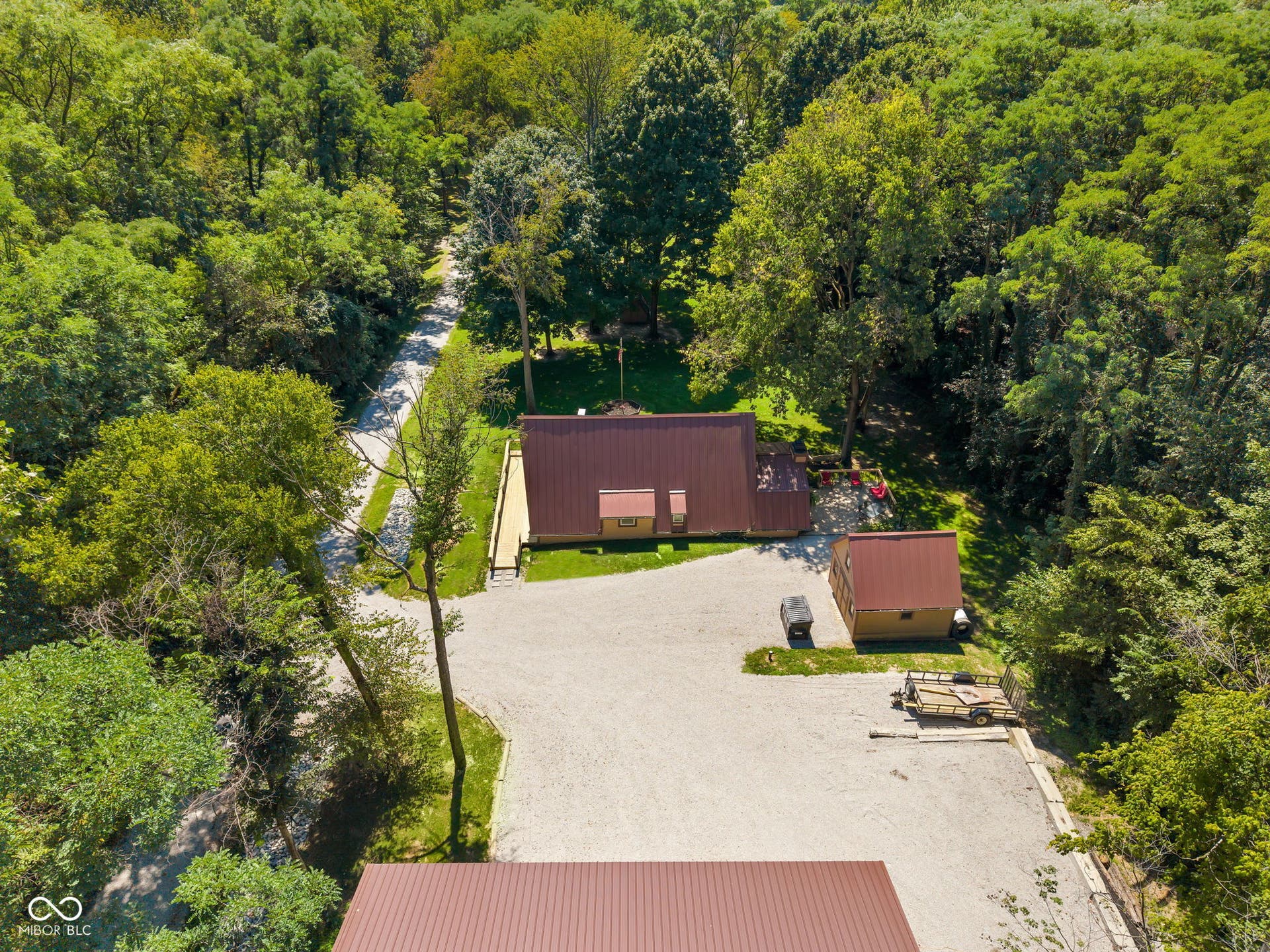 5432 W Whittier Drive, Knightstown, IN 46148 Wooded surroundings with a gravel driveway