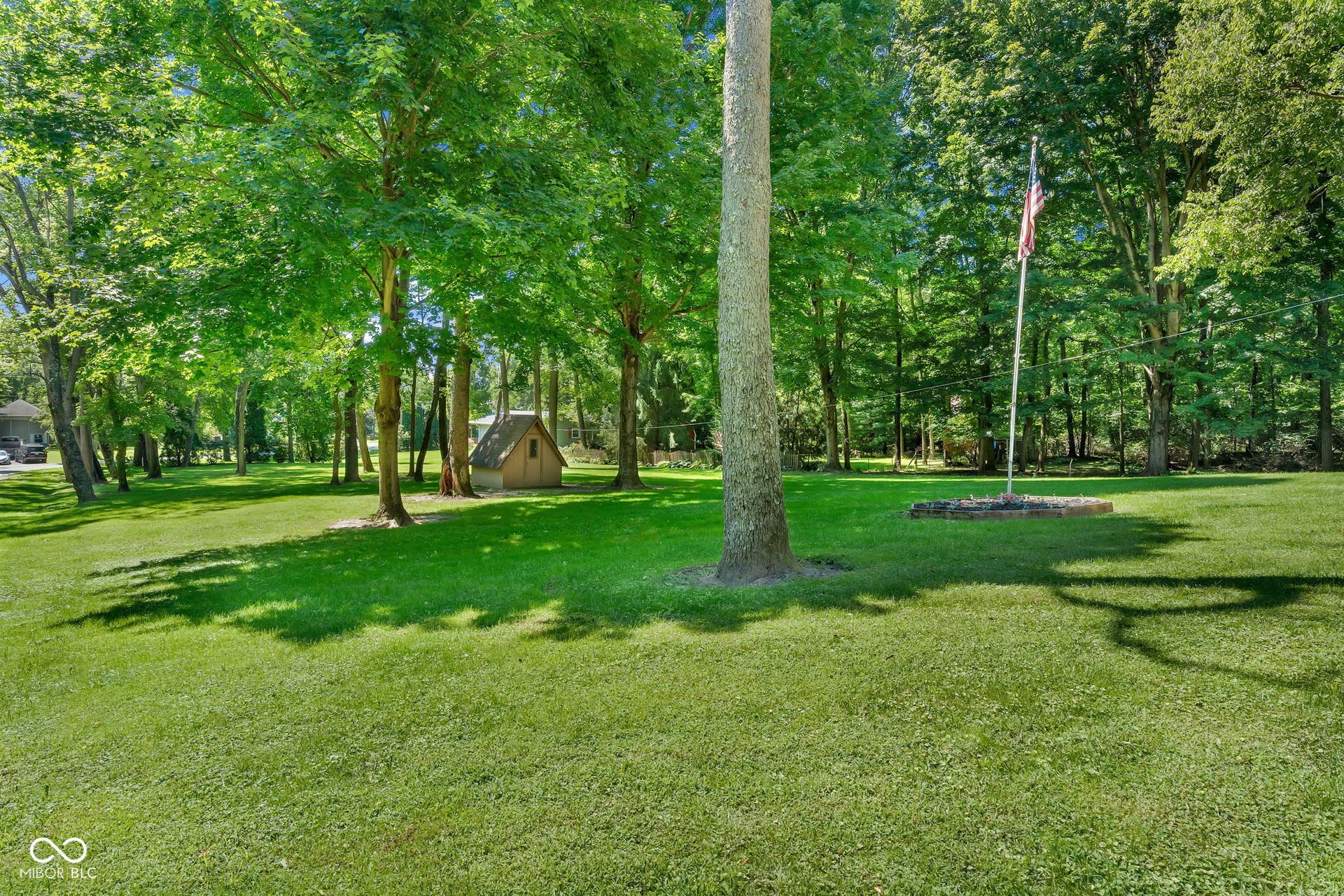 5432 W Whittier Drive, Knightstown, IN 46148 Mature tree-lined grounds with expansive manicured lawn and established hardwood specimens providing natural shade throughout the property