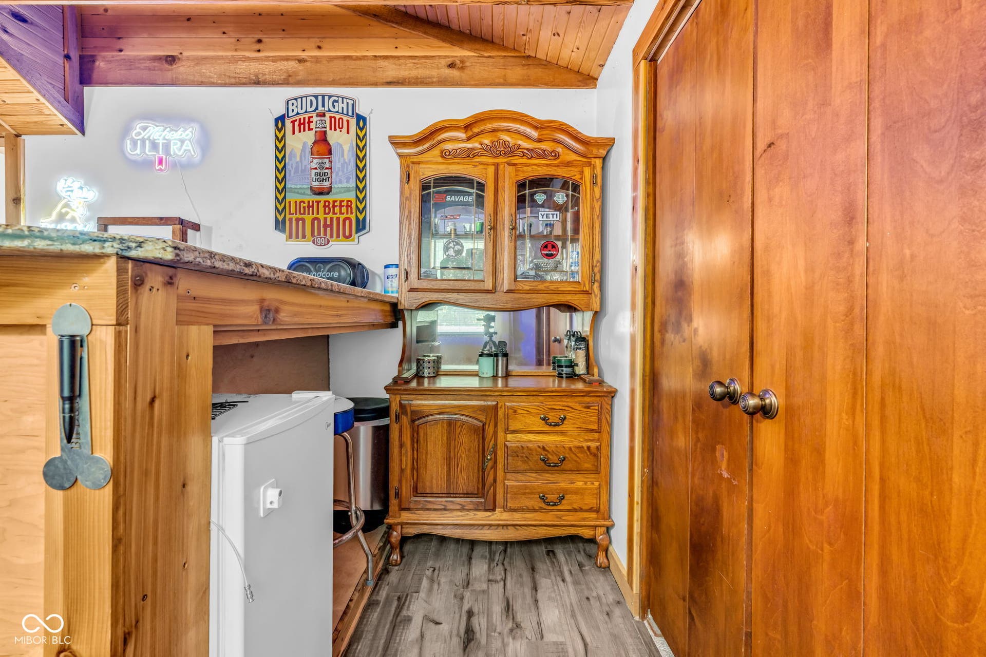 5432 W Whittier Drive, Knightstown, IN 46148 Wood-finish flooring, wood-paneled ceiling, wood-finish cabinetry, and built-in hutch with glass-front display
