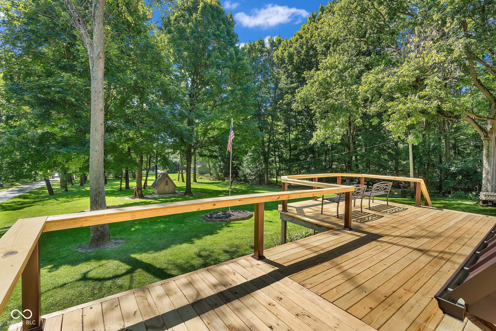 5432 W Whittier Drive, Knightstown, IN 46148 Expansive wood deck with a natural finish, featuring a surrounding wood railing