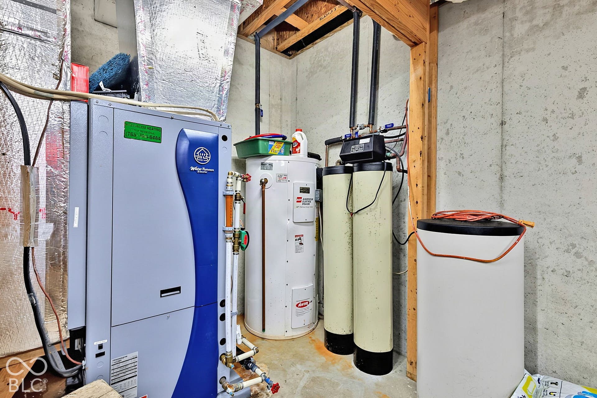 Comprehensive utility area featuring a water heater, water filtration system, and a geothermal HVAC unit