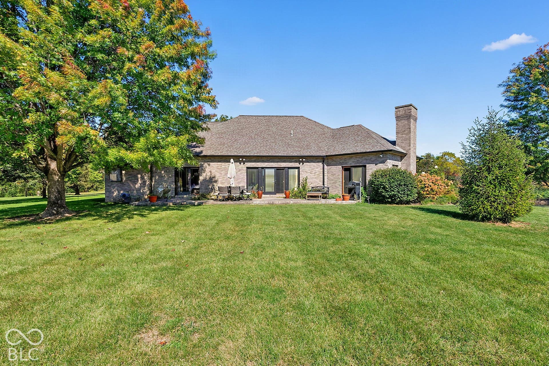 Expansive grassy yard with mature trees