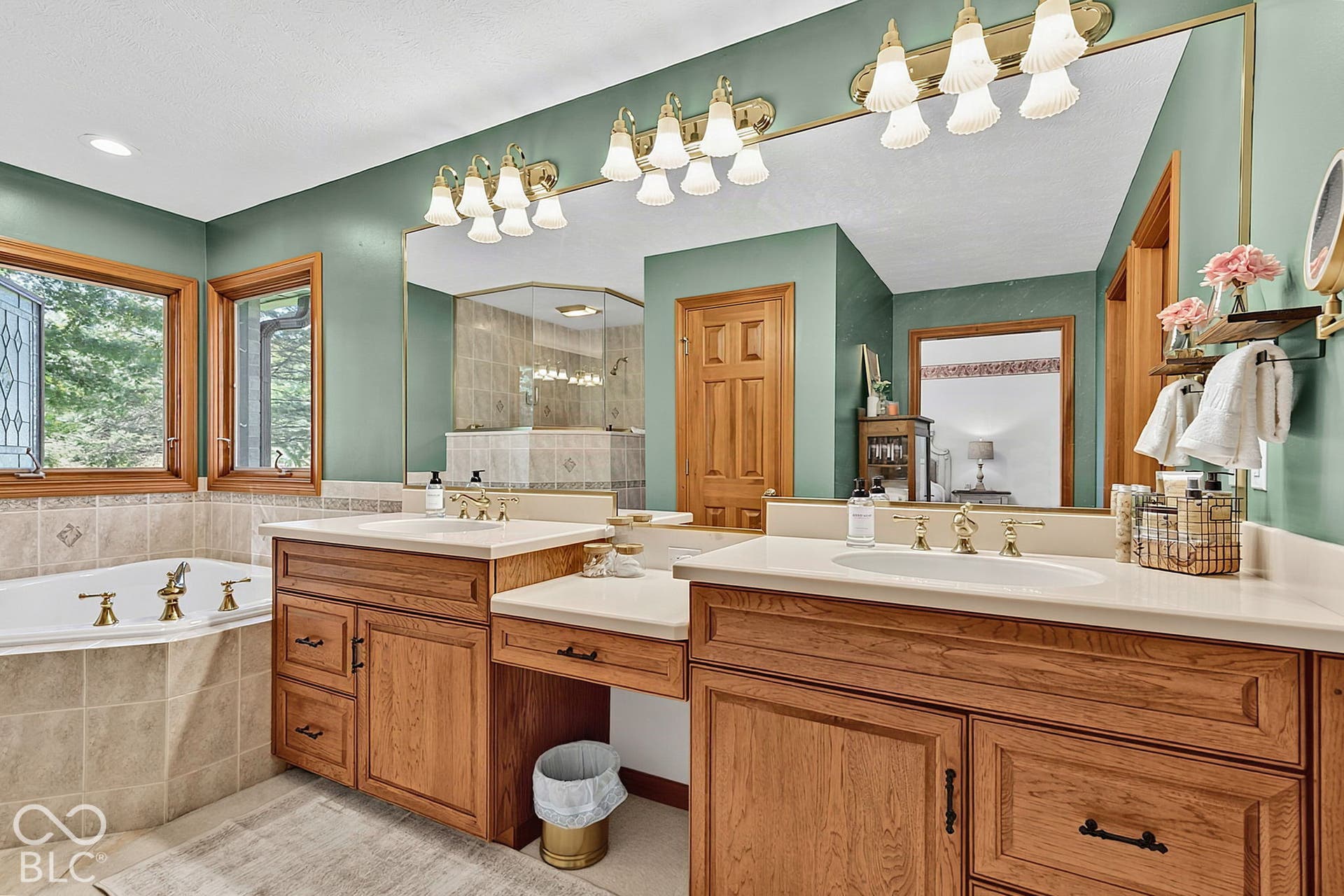 Dual wood-finish vanities with integrated sinks and ample storage