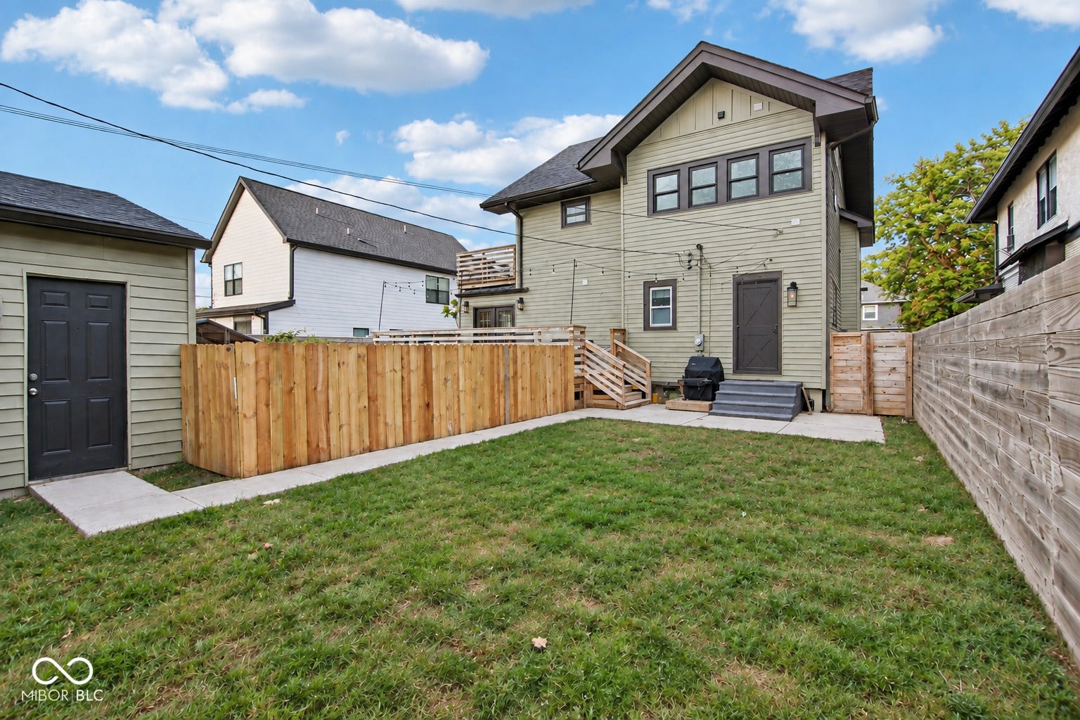 Expansive grass lawn with wood privacy fencing
