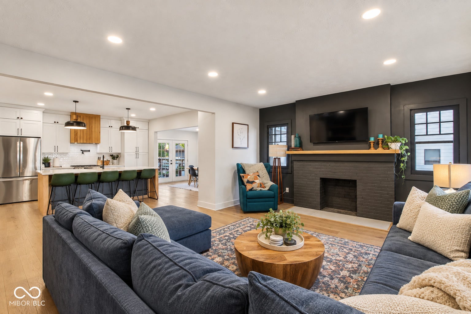 Virtually Altered - Open-concept living area with wood-finish flooring