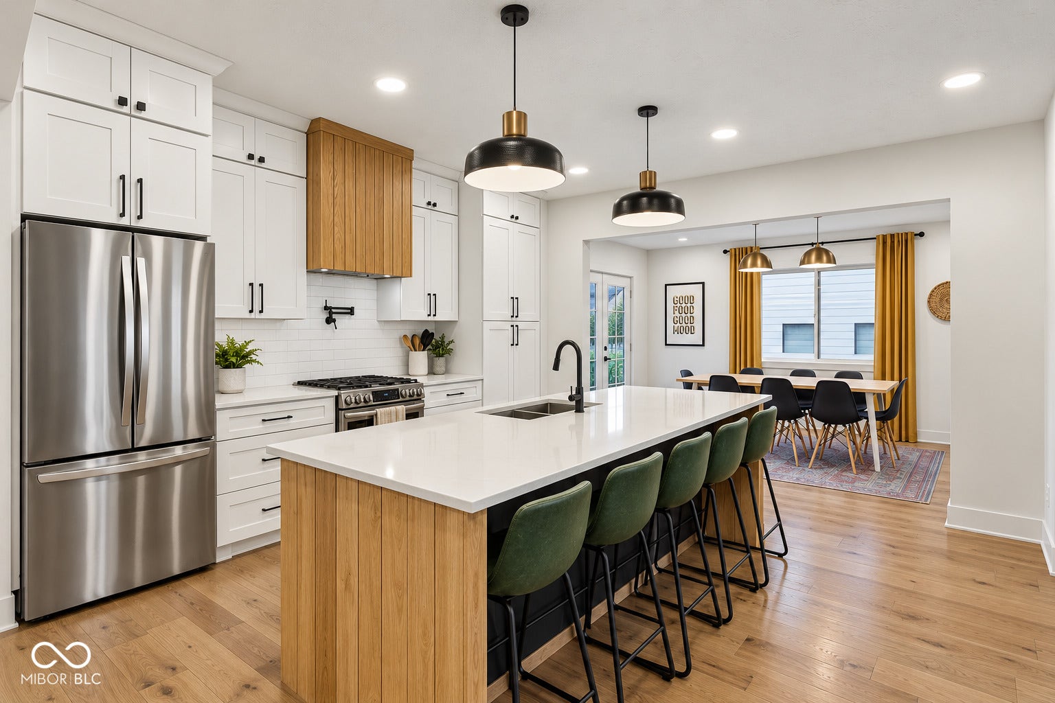 Kitchen featuring white cabinetry, stainless steel appliances, a center island with a white countertop, wood-finish flooring, and pendant lighting