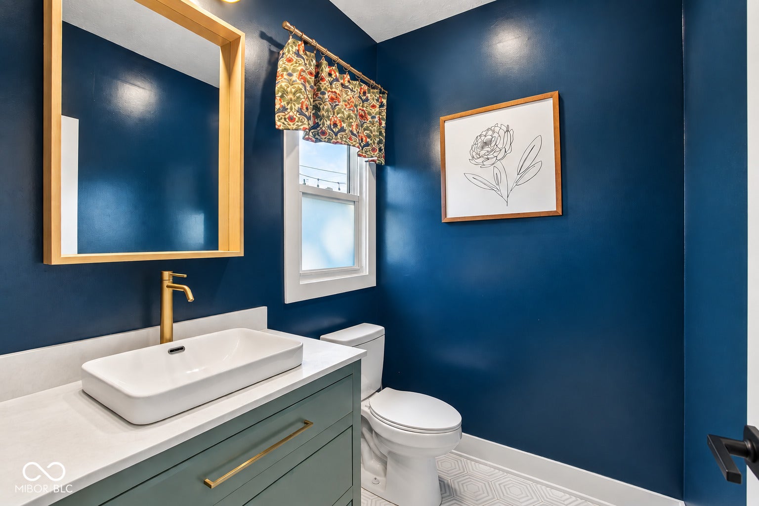 Half Bathroom on main floor featuring a rectangular vessel sink, gold-finish faucet, and a vanity with gold-finish hardware