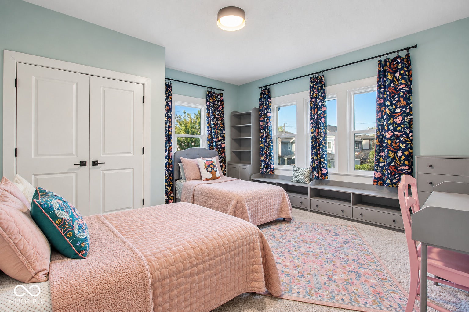 Bedroom 3: Double-panel closet doors, multiple windows providing natural light, built-in window seating, and built-in shelving