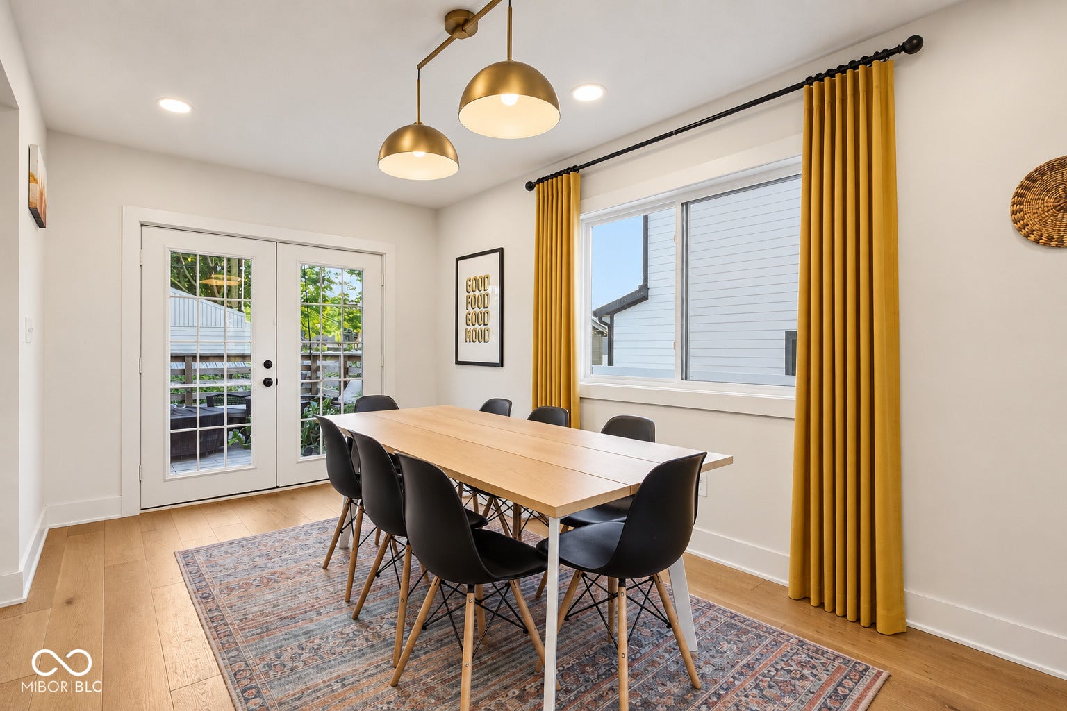 Hardwood flooring, recessed lighting, and a linear chandelier with brass finishes