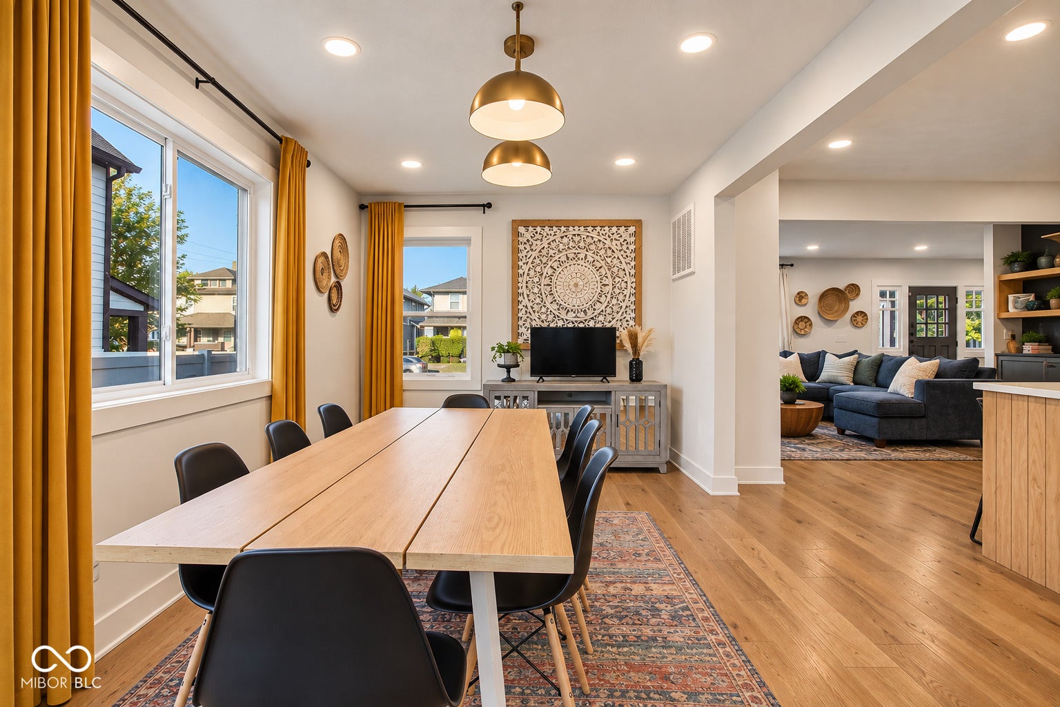 Recessed lighting illuminates the dining area and an open-concept living space