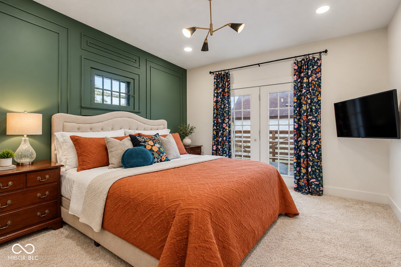 Panel accent wall, dual French doors, recessed lighting, wall-mounted television, and carpet flooring