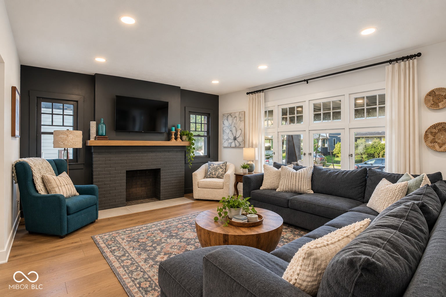Virtually Altered - Brick fireplace with a wood-finish mantel and recessed lighting