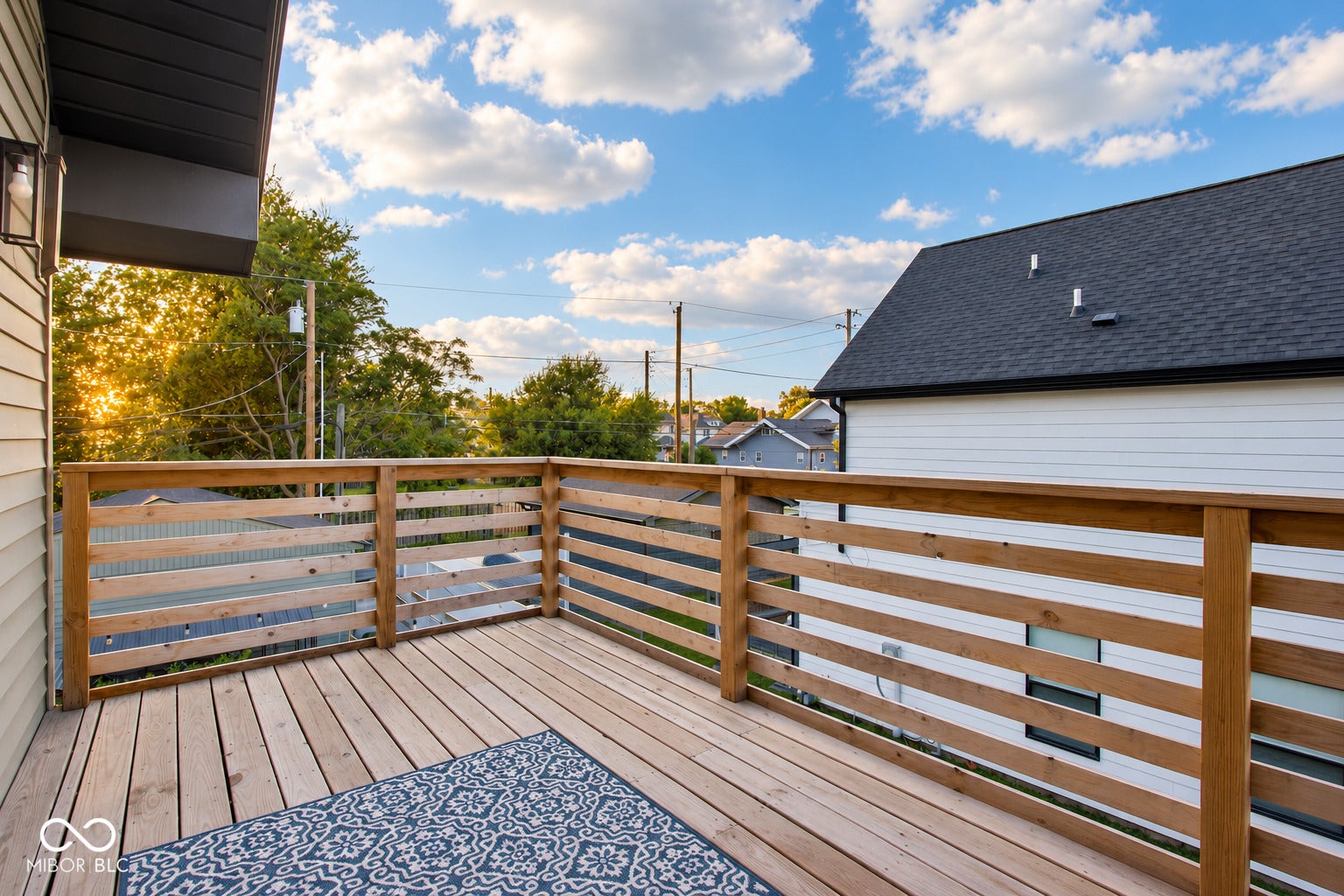 Virtually Altered - Upper Deck off the primary bedroom: Expansive outdoor deck featuring wood-finish flooring and a horizontal slat railing