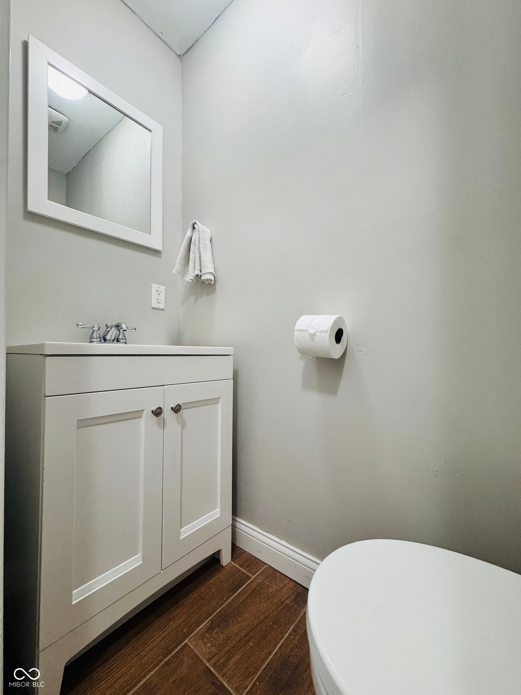 Half bathroom conveniently located near the back door, perfect access for guests when entertaining outdoors