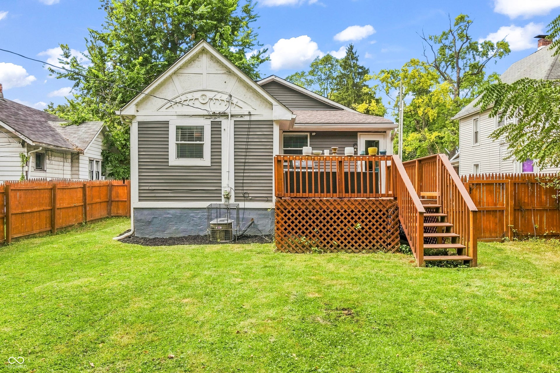 Attached wooden deck with lattice detailing