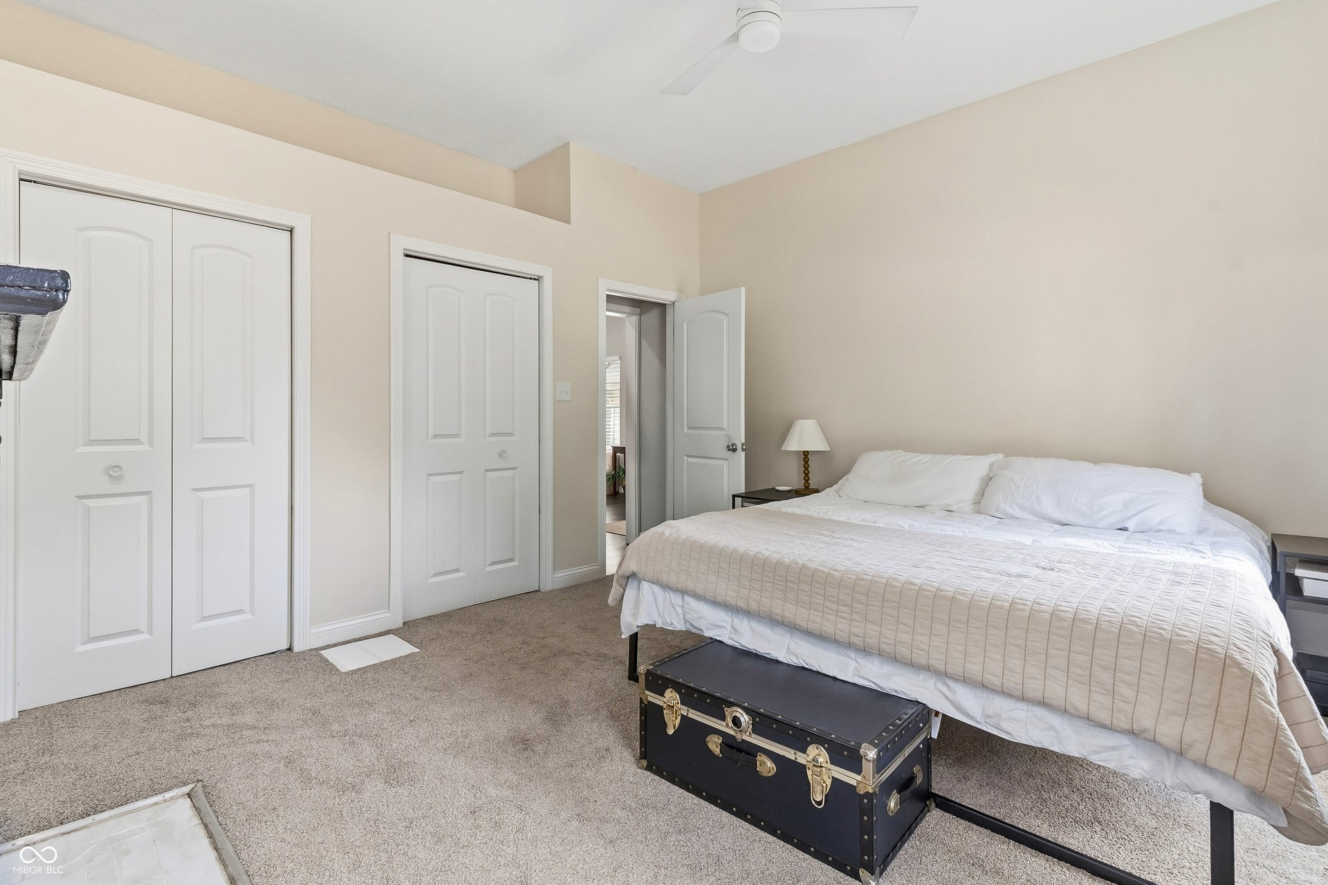 Side-by-side closet doors with built-in shelving, closet connects in the middle