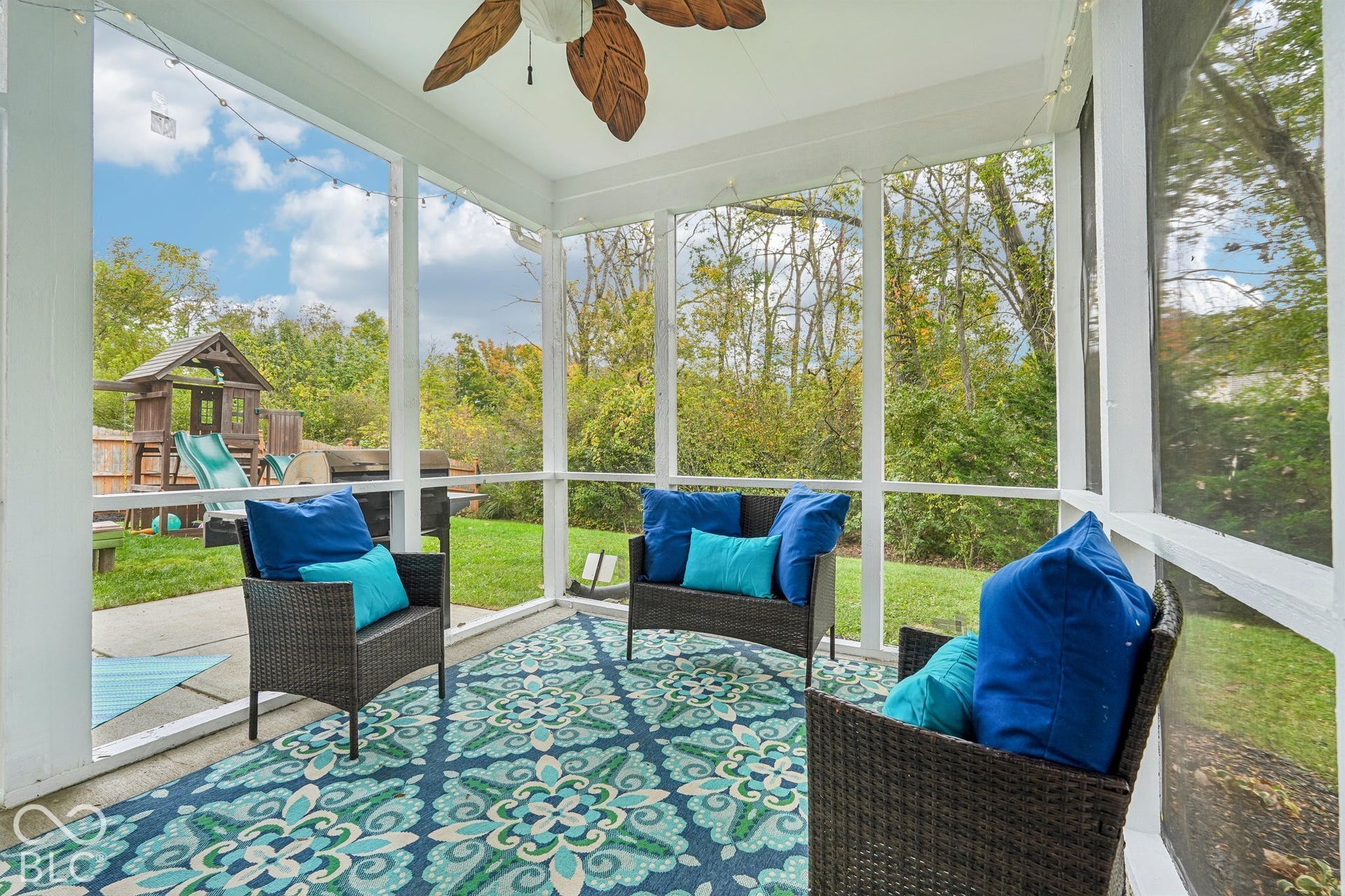 Screened in porch overlooks the private backyard