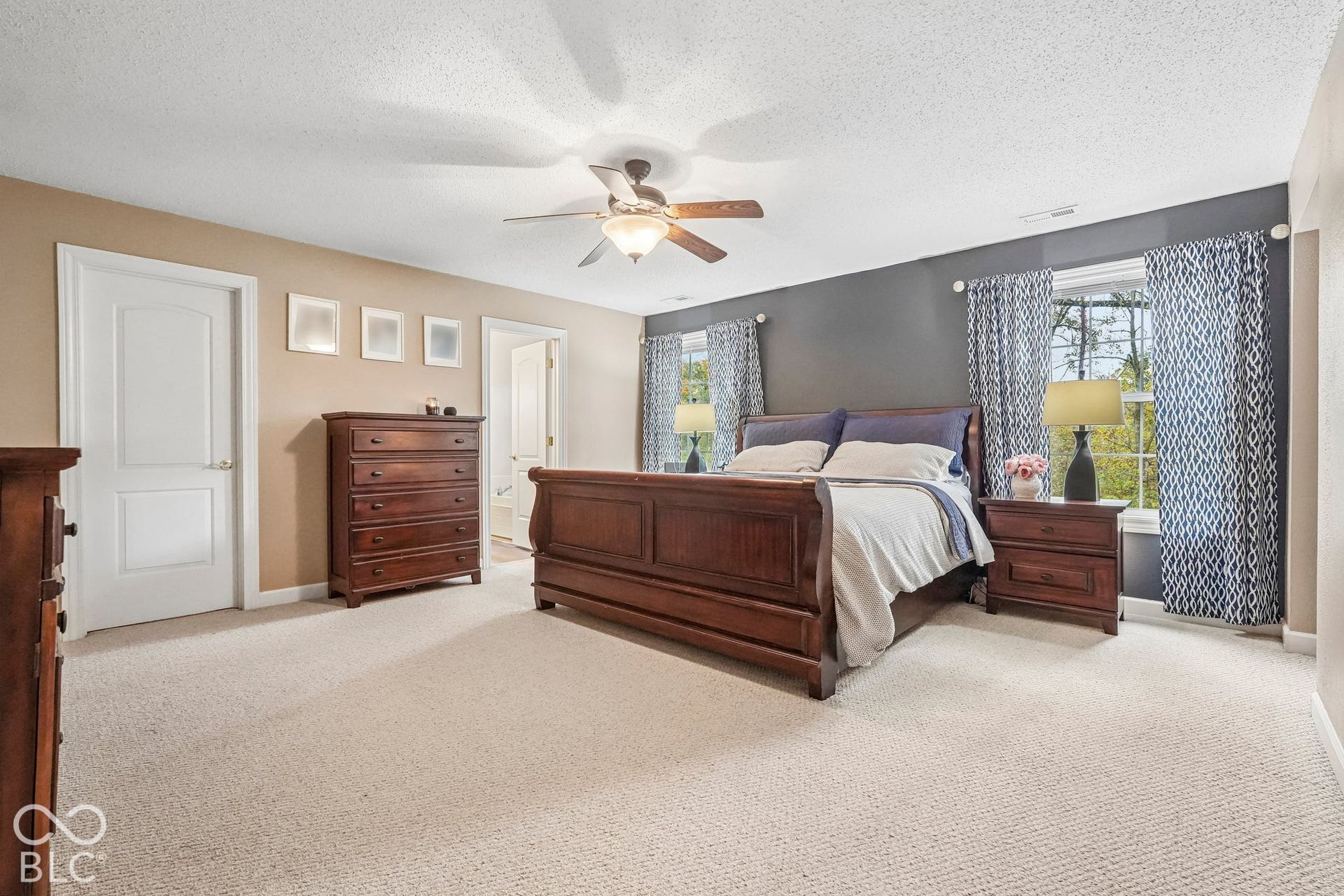 Expansive primary suite offers sitting room, large walk-in closet, and ensuite bathroom