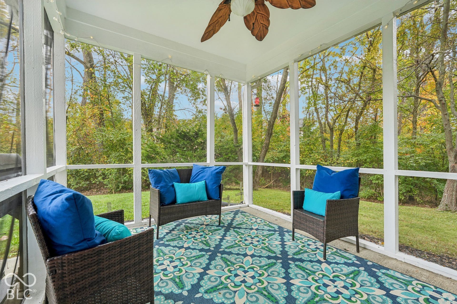 Covered back porch offers great views of the woods and private backyard