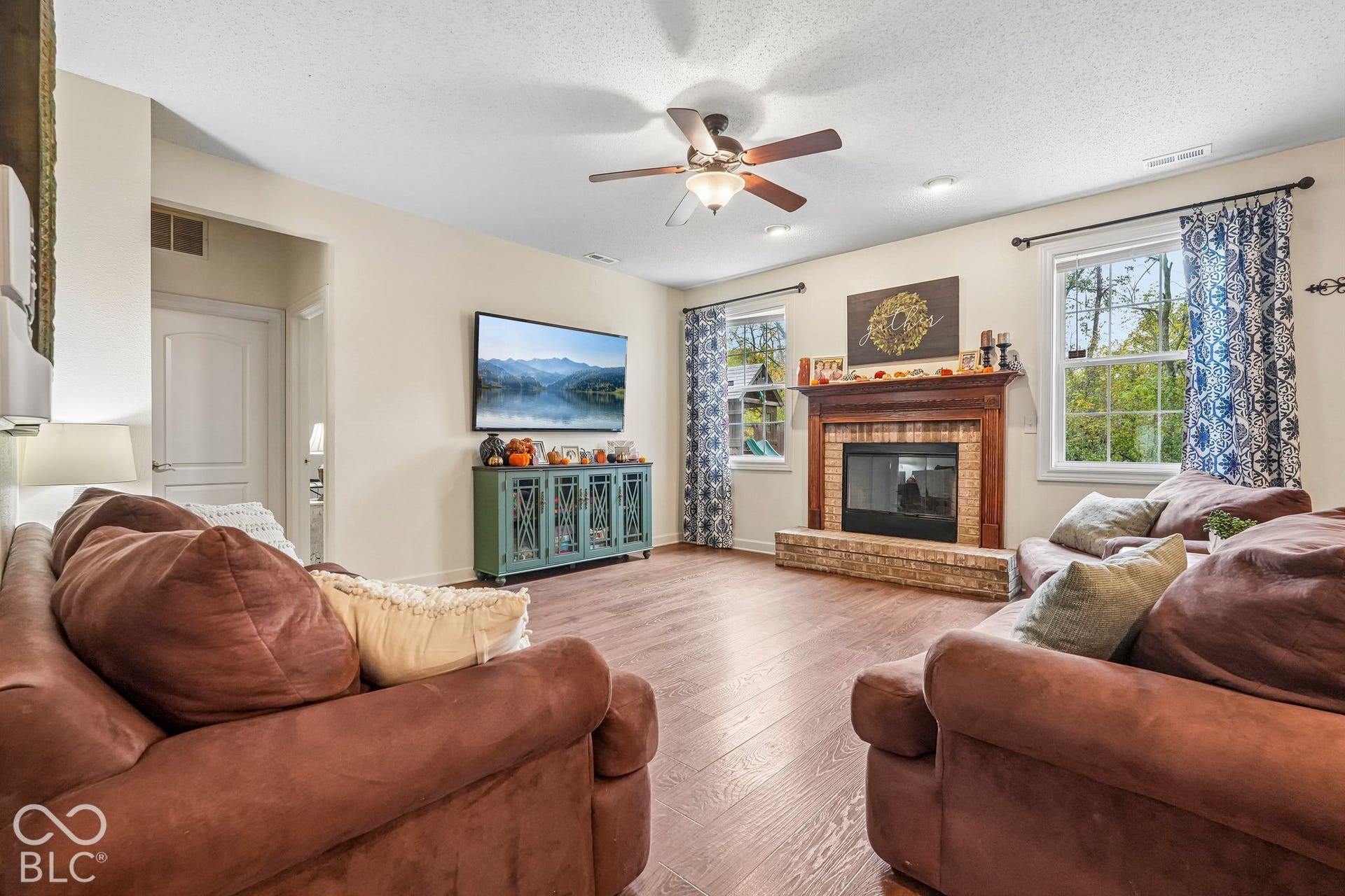 Family room offers cozy wood burning fireplace and views of the private backyard