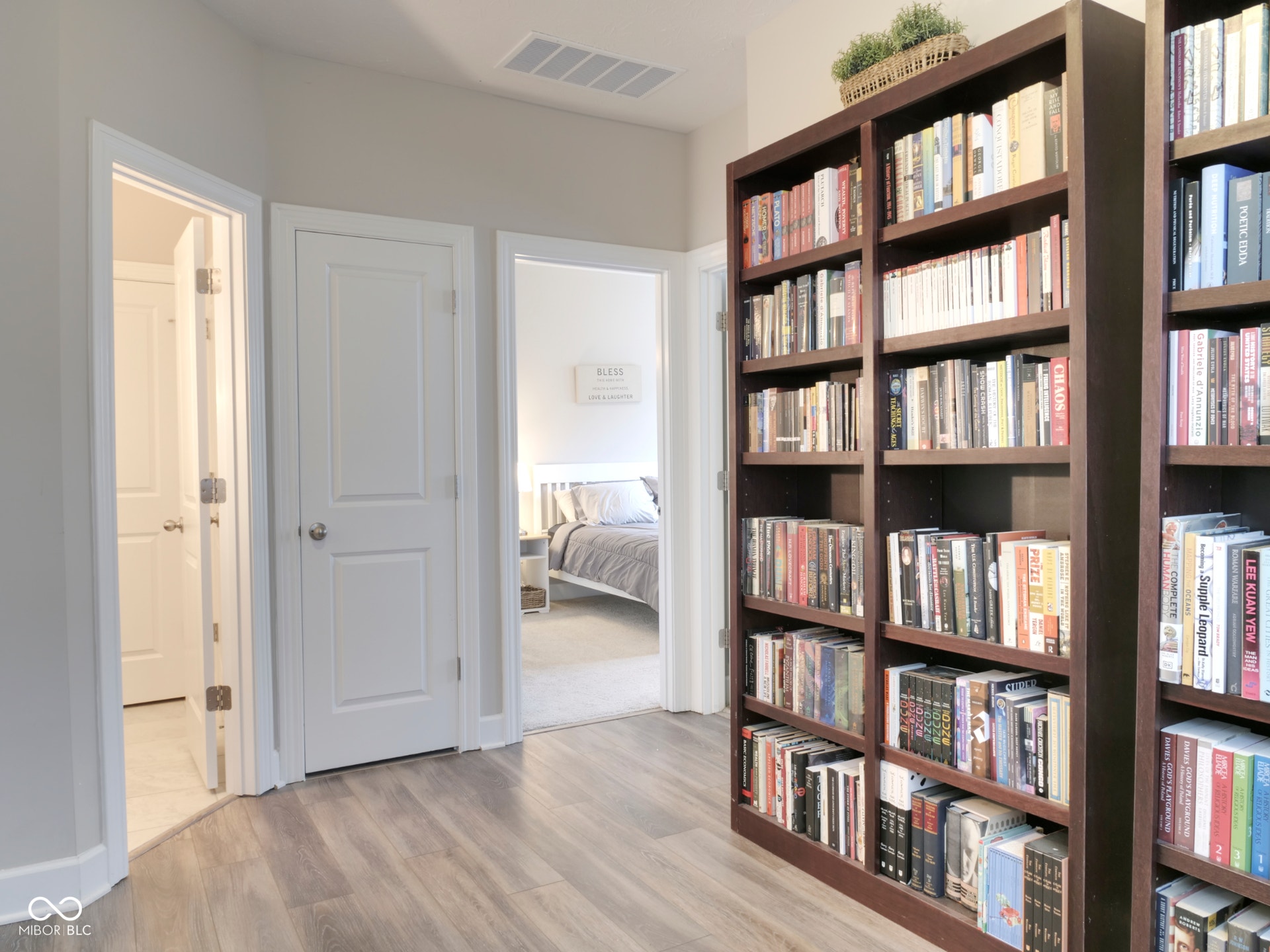 Wood-finish flooring throughout, complemented by light gray wall paint