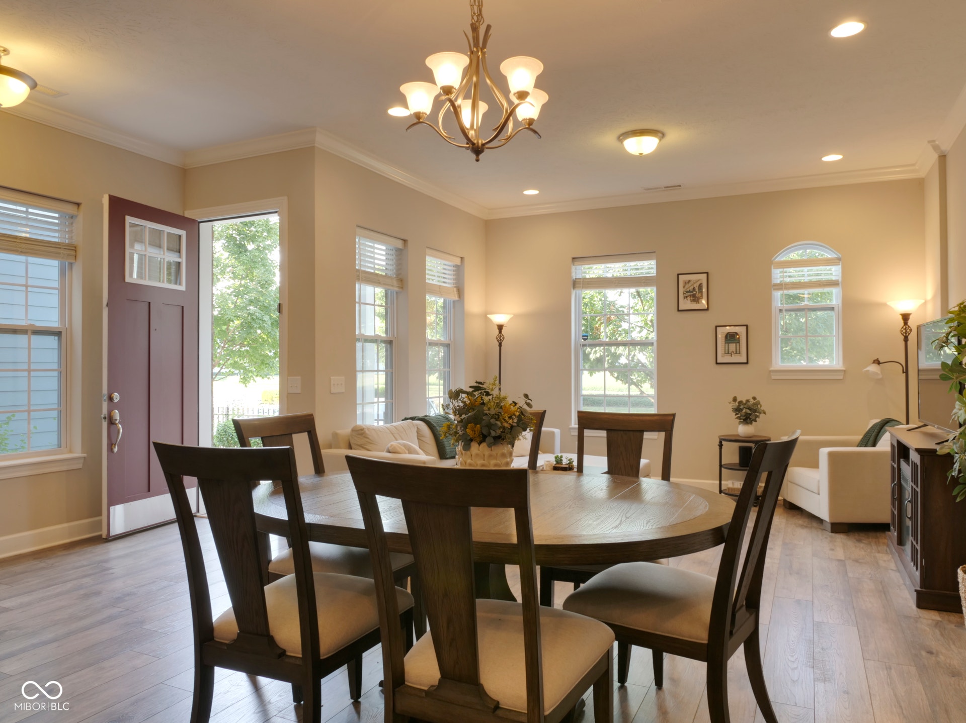 Wood-finish flooring throughout, crown molding, and multiple windows